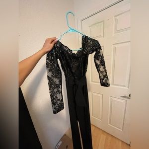 All black jumpsuit, front tie, laced top